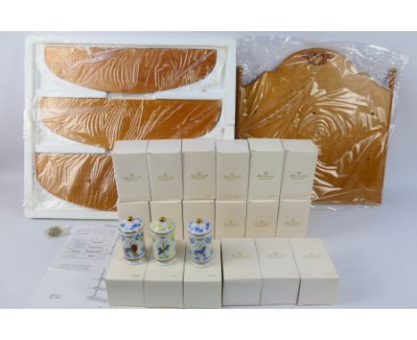 A set of twenty four boxed porcelain spice jars, contained in original shipping box and a spice rack. [5]. [W]