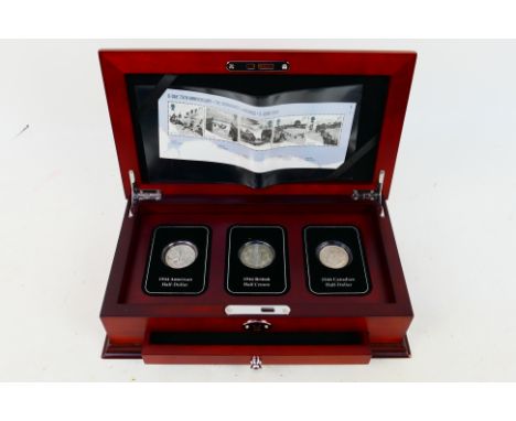 A Danbury Mint, D-Day Allied Forces Silver Coin Set comprising a 1944 Half Crown, US Half Dollar and Canadian Half Dollar, a 