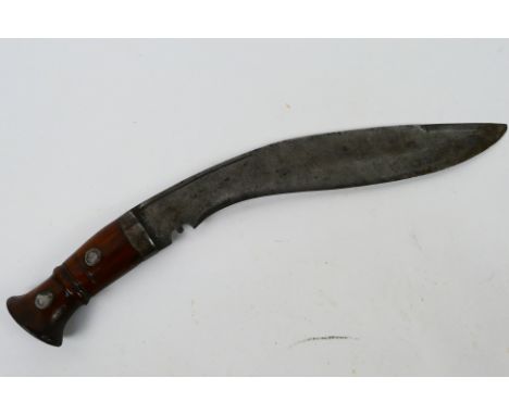 A vintage kukri with 30 cm (l) blade, wooden hilt and steel chapri. [W]Note: This lot is not for sale to people under the age