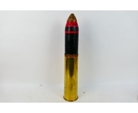 A World War One (WW1 / WWI) British 18 Pounder artillery shell projectile with fuze and brass shell case. The cartridge paint