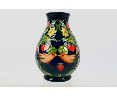 Moorcroft - A Moorcroft Pottery vase decorated in the Strawberry Thief pattern with birds and strawberry plants reserved agai