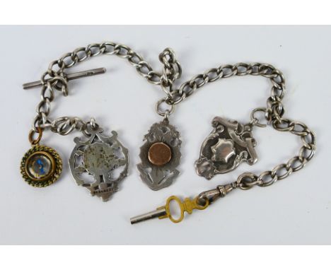 An antique silver pocket watch chain with T-bar, three silver fobs and one yellow metal miniature compass fob, 33 cm (l), app