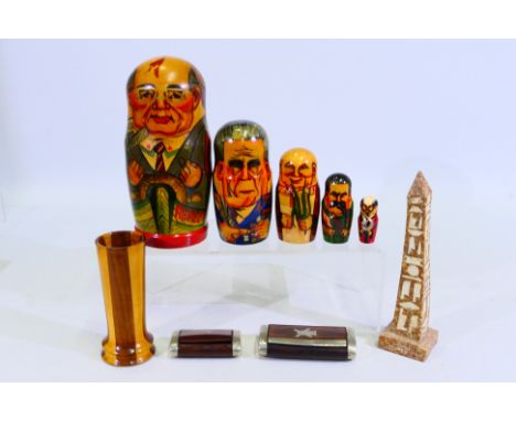 A set of Russian president matryoshka dolls, two wood and white metal snuff boxes, stone obelisk (20 cm height) and other. [W