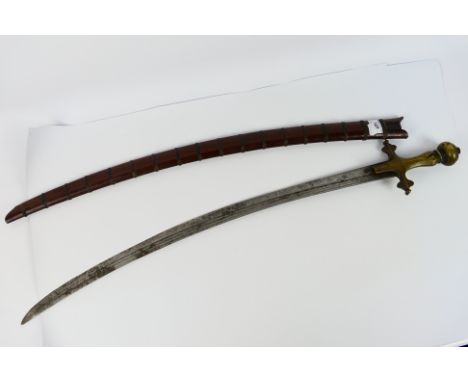 A late 19th century Piso Podang sword with single edged steel blade, 71 cm (l), having three shallow fullers each side, brass