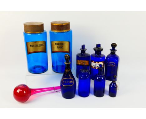 A collection of blue glass apothecary and similar jars, largest approximately 26 cm (h) and a chemist's show globe. [W]NOTE: 