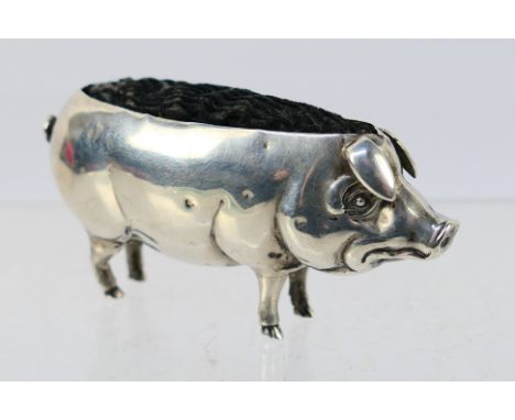 An Edwardian silver, novelty pin cushion in the form of a pig, Birmingham assay 1905, sponsors mark for Adie & Lovekin Ltd, a