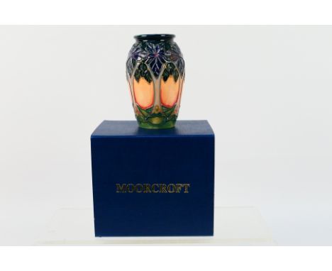 Moorcroft - A small Moorcroft Pottery vase decorated in the Cluny pattern, 1994 (silver line to the base) approximately 10 cm