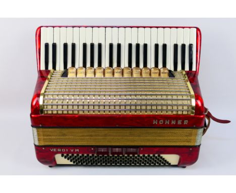 A vintage Hohner Verdi VM piano accordion, 41 keys and 120 basses, marbled red finish, contained in carry case. Note: Vendor 