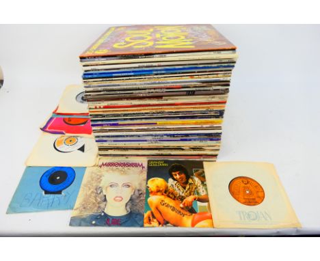 A collection of 12" and 7" vinyl records to include Michael Jackson, The Beach Boys, Fleetwood Mac, Status Quo, The Human Lea