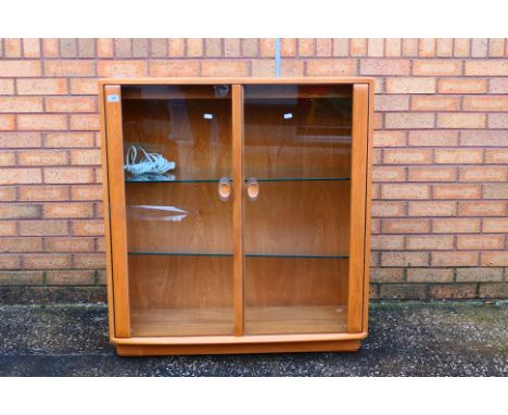 Ercol - A Windsor twin door display cabinet with adjustable glass shelves, approximately 98 cm x 91 cm x 31 cm. [W]