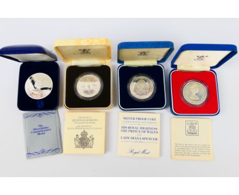 Four silver proof coins comprising The Silver Jubilee Commemorative Medal, Queen Mother 80th Birthday Commemorative Crown, Si