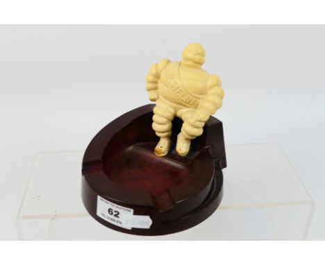 A vintage advertising ashtray for Michelin, c.1940's, bakelite construction with Bibendum figure seated on the rim, 12 cm (h)
