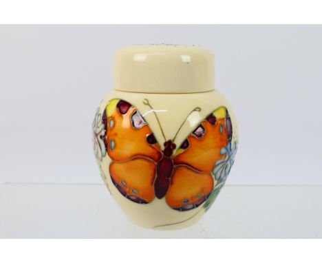 Moorcroft - A Moorcroft Pottery jar and cover, 1994, decorated in the Butterfly pattern reserved against a cream ground, impr