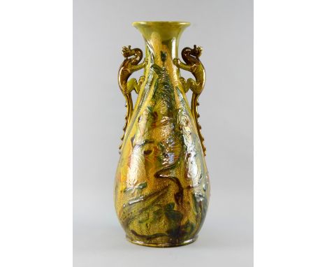 A Brannam Barum Art Nouveau Oviform vase  the handles in the form of dragons dragon handles decorated with flowers and leaves