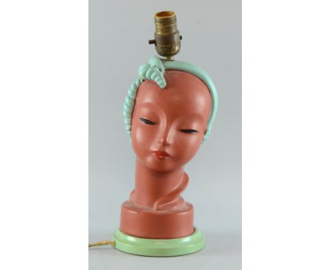Lamp In the manner of Goldscheider  in the form of a girls head probably by Goldscheider On turned wooden base, with original