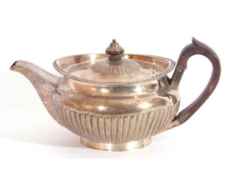 George III silver teapot of rounded form and part fluted detail with an applied gadrooned rim, on a reeded collet foot, hallm