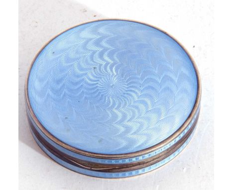 Continental white metal and enamel circular box the lid and sides with a light blue guilloche design, the hinged lid opening 