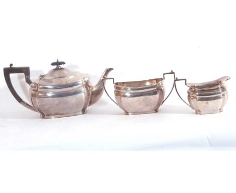 George V silver three piece tea set of plain form with cantered corners comprising teapot, twin handle sucrier and jug, hallm