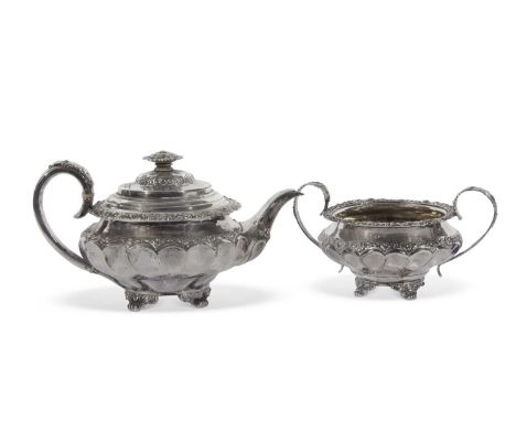 George IV teapot of ribbon fluted compressed circular form embossed and chased with shell, floral and foliate detail througho