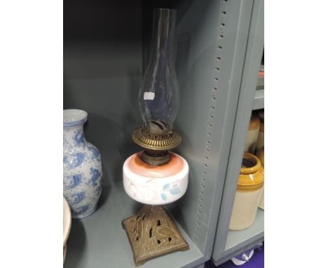 An oil burning lamp with ceramic base and cast base with stork design