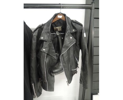 A pair of vintage leather boots and a leather motorcycle jacket. Boots look to be an 8 or 9 in size, jacket a medium size.