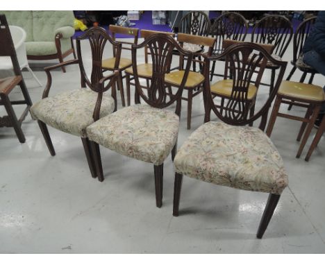 A set of three (2+1) 20th century mahogany dining chairs in the Sheraton shield back style, having tapestry seats and reeded 