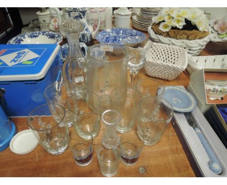 A hand decorated glass jug and pitcher set