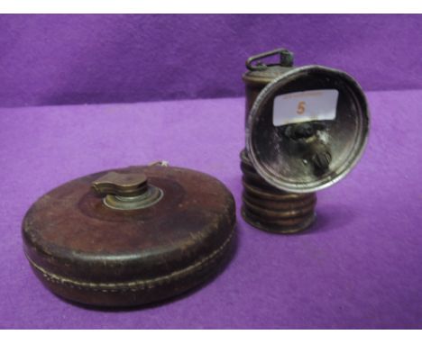 An early carbide style cycle or similar lamp by Premier and leather measure