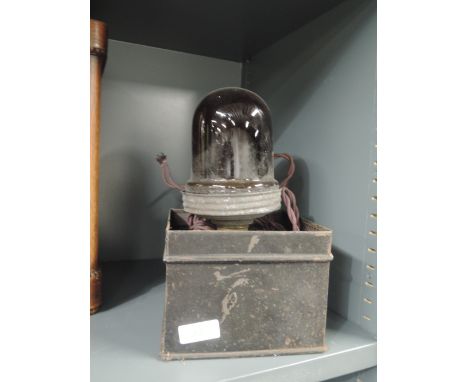 A photographers dark light with heavy set red glass lamp