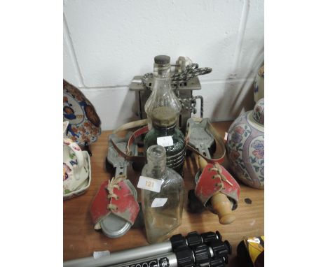 A pair of vintage roller skates and advertising bottles