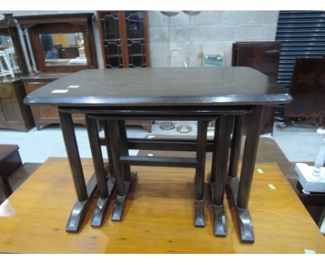 A dark stained nest of three Ercol tablesGood condition, very slight wear, no cracks or chips
