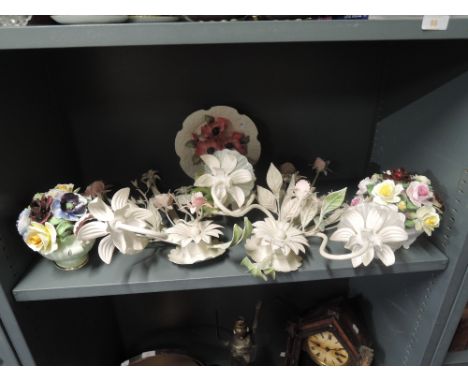 A selection of floral design decorations including ceramic and metal