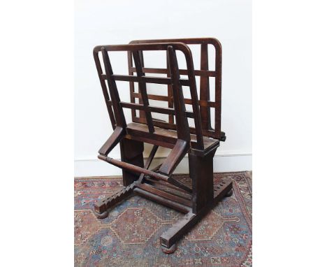 Early 20th century oak folio stand with adjustable lattice supports, on H-shaped base and castors, 67cm wide