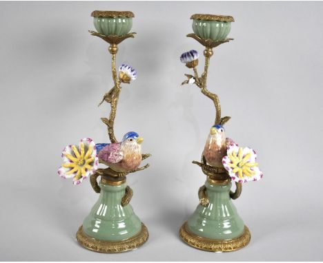 A Pair of Ceramic and Bronze Candlesticks in the Form of Birds in Flowers, Each 31cms High 