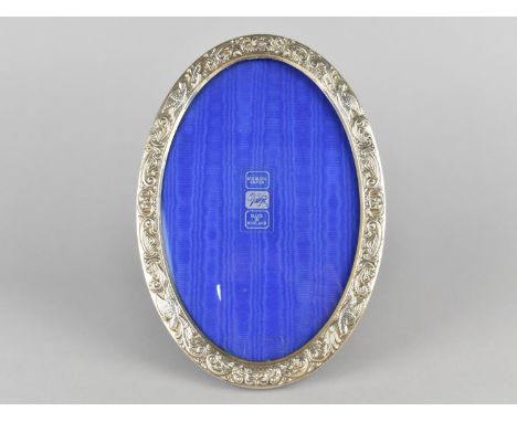 An Oval Sterling Silver Photo Frame with Relief Bird and Scroll Border, 16.5x24cm 
