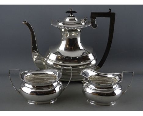 A HANDSOME SILVER COFFEE POT with long spout, narrow neck, four ball supports and composition handle and knop, 23.5 troy ozs 
