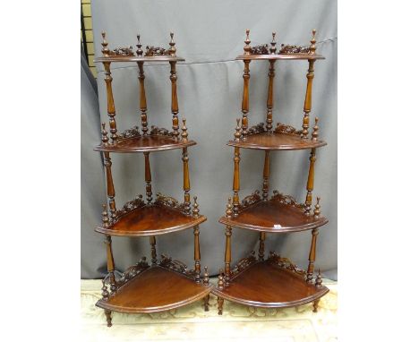 A GOOD PAIR OF REPRODUCTION MAHOGANY FOUR SHELF CORNER WHATNOTS, the shelves having carved rail detail, 143 cms high