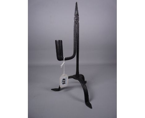 A TRIPOD STEEL RUSH LIGHT HOLDER on three pad supports, 29 cms high