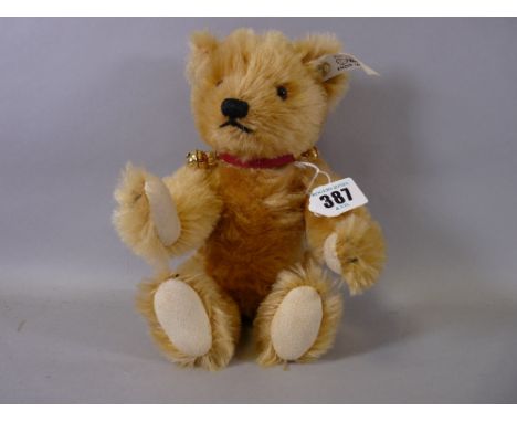 A STEIFF 'BUTTON IN EAR' TEDDY BEAR, 1993 blonde mohair limited edition (00344/1500), wearing a red collar with gilt bells, 2