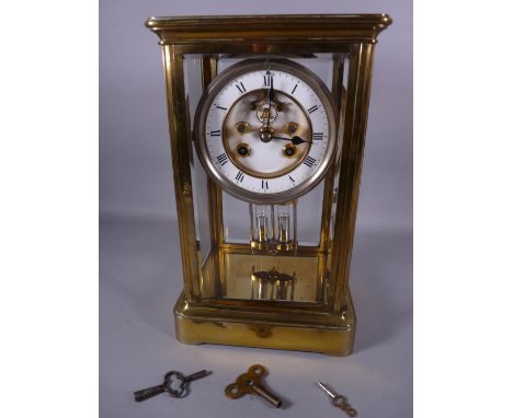 A FRENCH FOUR GLASS, BRASS CASED MANTEL CLOCK, white enamel dial with visible escapement, set with Roman numerals, circular b