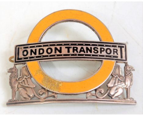 A London Transport hallmarked silver winged Griffin inspectors cap badge, some loss to yellow enamel on circle No. 3819 on re