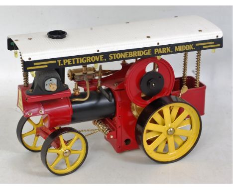 A Wilesco Live Steam showman's engine, comprising of red, black and yellow body with base metal fittings, Model No. D409, app