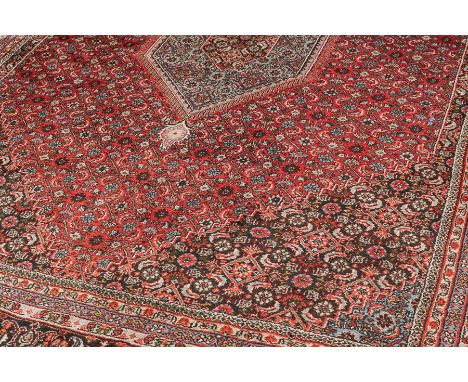 HAMADAN BORDERED CARPET
decorated with a large central medallion filled with small flowerheads, 345cm long, 250cm wide