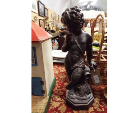 A carved wooden cherub playing a pan flute instrument