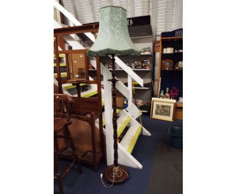 An antique turned oak lamp stand and shade
