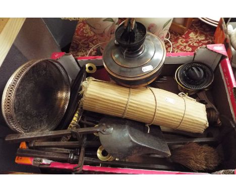 A selection of miscellaneous items to include a wrought iron companion set, brass candlesticks, a copper oil lamp, silver-pla