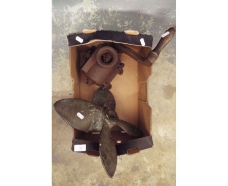 A metal propeller along with a vintage meat grinder