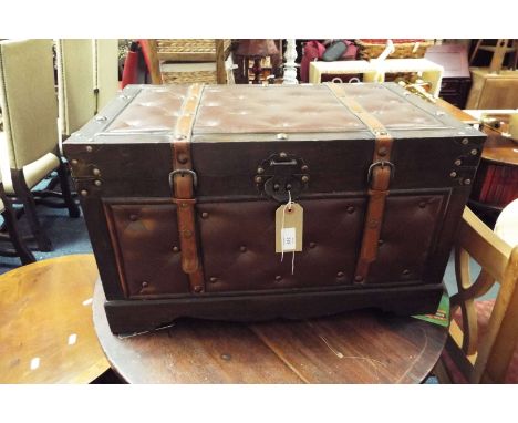 A wood and leather bound reproduction trunk
