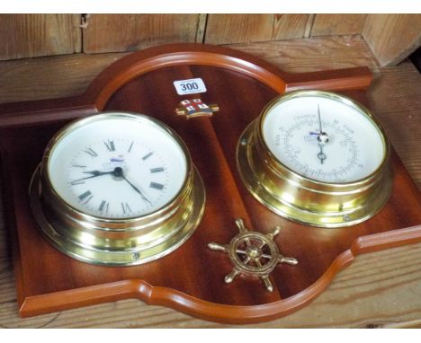 A framed ships clock with barometer and a modern striking wall clock 