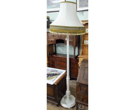 A white painted standard lamp with fringed shade 